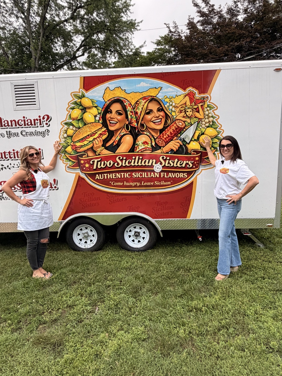 The two sisters today, standing beside their Two Sicilian Sisters food truck