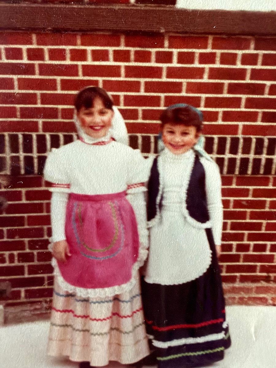 The two sisters as young girls in traditional Sicilian dresses